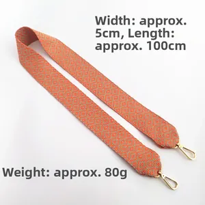 Detail view of 5cm wide ethnic geometric woven strap with golden lobster clasps