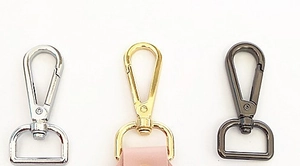 Close-up of metal lobster clasps in silver, gold and gunmetal for bag straps