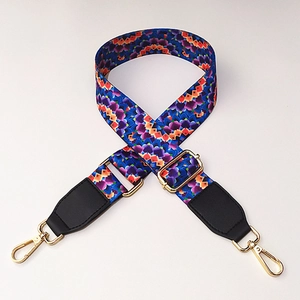 Detail of colorful ethnic wide bag strap with golden metal buckles and geometric pattern