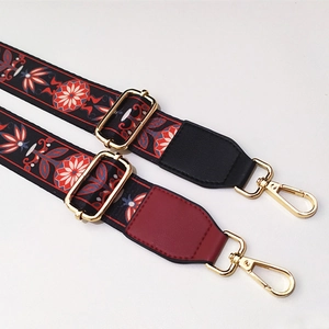 Detail of adjustable bohemian wide bag straps with vintage floral patterns and gold hooks