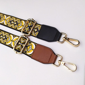 Detail of adjustable ethnic style bag straps with gold hardware and leather finish