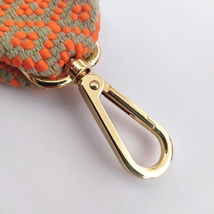 Ethnic wide bag strap with golden lobster clasp and orange-beige woven texture