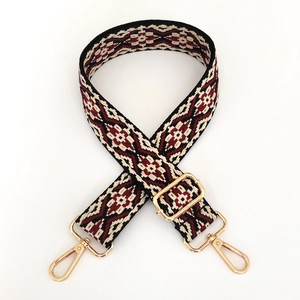 Close-up of ethnic geometric jacquard woven bag strap with gold metal swivel lobster hooks