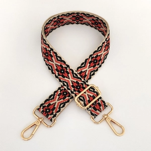 Detail of colorful jacquard guitar style bag strap with gold metal swivel hooks