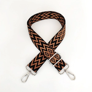 Detail of retro woven shoulder strap with black and caramel geometric diamond patterns
