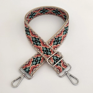 Detail of bohemian jacquard bag strap with ethnic patterns and silver metal hardware