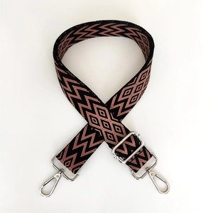 Detail of adjustable wide shoulder strap with purple geometric jacquard and silver buckles