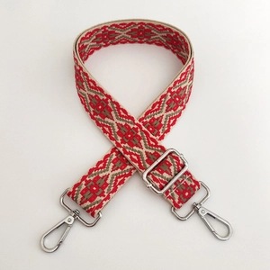 Close-up of ethnic jacquard weave bag strap with silver metal lobster clasps and buckles