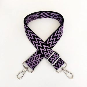 Detail of adjustable purple and black jacquard shoulder strap with silver swivel hooks