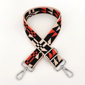 Detail of colorful woven shoulder strap with geometric ethnic pattern and metal clips