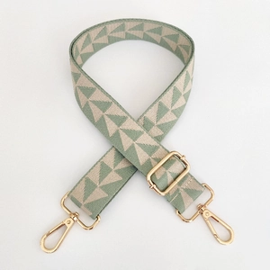 Detail of adjustable geometric strap with gold lobster clasps in green and cream