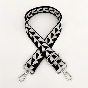 Close-up of adjustable wide fabric strap with black and white geometric triangle patterns