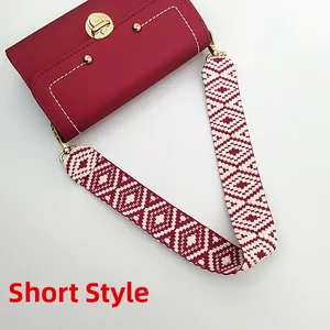 Short style effect showing a red leather shoulder bag with ethnic patterned wide strap