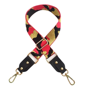Adjustable wide leopard print bag strap in red, black and gold with swivel metal hooks