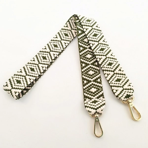 Close-up of ethnic geometric pattern webbing with golden swivel lobster clasps for bags