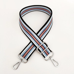 Close-up of adjustable striped canvas shoulder strap with silver lobster clasps