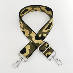 Detail of army green and gold leopard pattern strap with shiny silver metal lobster clasps