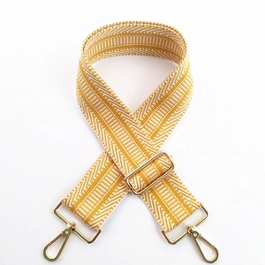Detail of yellow and white geometric embroidery on thick adjustable wide bag strap