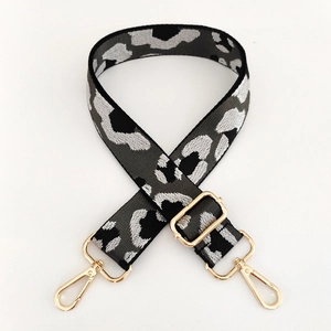 Detail of adjustable leopard print bag strap with polished gold-tone metal lobster clasps