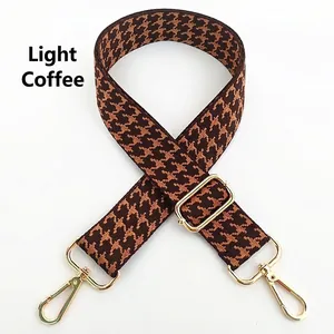 Detail of adjustable light coffee houndstooth strap with golden metal lobster hooks