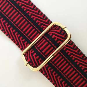 Adjustable wide shoulder strap with red and black geometric embroidery and gold buckle