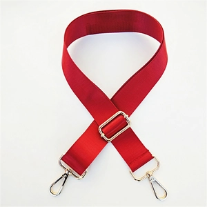 Close-up of red nylon wide shoulder strap with golden metal lobster clasps and buckles