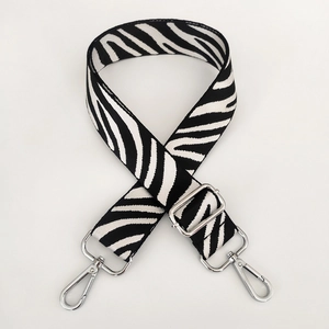 Detail of zebra pattern nylon strap with adjustable silver metal buckle and swivel hooks