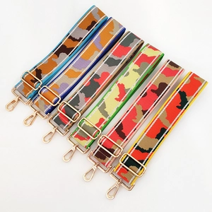 Flat lay of six adjustable thick woven camera straps with camouflage patterns and gold hooks
