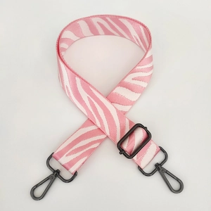 Detail of pink and white zebra pattern strap with matte black metal hardware
