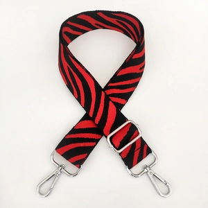 Detail of red and black zebra pattern nylon strap with silver metal swivel hooks