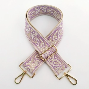 Close-up of purple paisley embroidered wide strap with premium golden metal lobster clasps