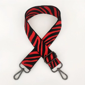 Close-up of red and black zebra pattern nylon replacement strap with gunmetal lobster clasps