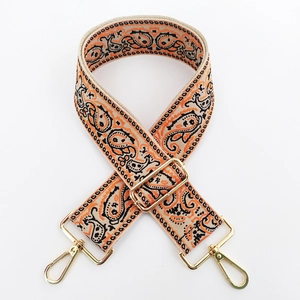 Detail of ethnic paisley embroidered bag strap with premium gold metal lobster clasps