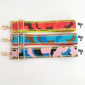 Three colorful camouflage wide shoulder straps with gold metal hooks numbered 1 to 3