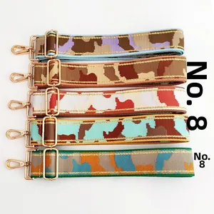 Detail of five colorful thick camouflage shoulder straps with gold metal hooks and buckles
