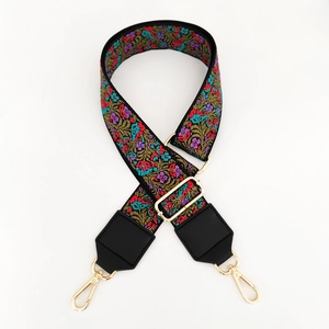 Detailed view of floral embroidery and golden metal swivel hooks on ethnic bag strap