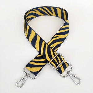 Adjustable woven strap with blue and yellow tiger pattern and silver metal clasps