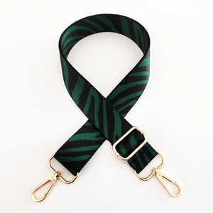 Detail of green zebra pattern wide replacement strap with gold metal lobster clasps