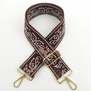 Detail of paisley embroidery fabric strap with adjustable gold metal lobster clasps