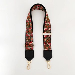 Detail of bohemian floral embroidered jacquard bag strap with gold metal swivel hooks