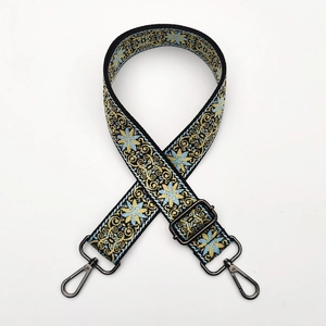 Detail of ethnic floral jacquard strap with adjustable dark grey metal buckles