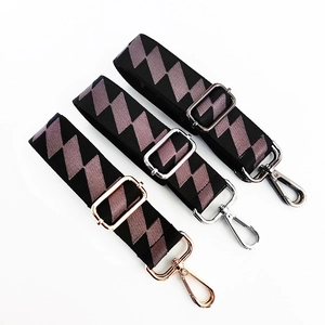 Detailed view of adjustable wide shoulder straps with geometric patterns and metal buckles