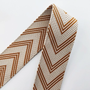 Close-up of thick woven shoulder strap with brown and beige herringbone pattern