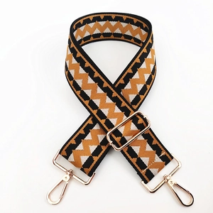 Adjustable canvas shoulder strap with yellow geometric pattern and gold metal hooks