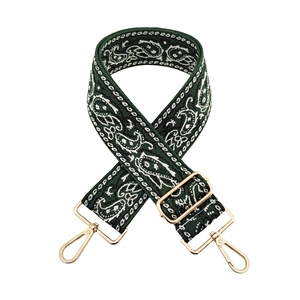 Detail of green paisley embroidered wide bag strap with premium gold metal lobster clasps