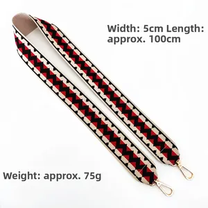 Detail of 5cm wide red and black zigzag woven strap with gold metal snap hooks