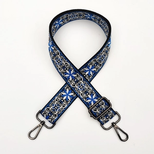 Detailed close-up of ethnic floral embroidery and gunmetal buckles on the adjustable strap