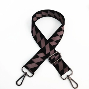 Detail of adjustable wide shoulder strap with geometric diamond pattern and metal hooks