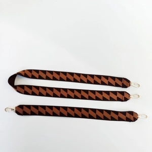 Wide jacquard strap with brown geometric patterns and gold metal swivel hooks