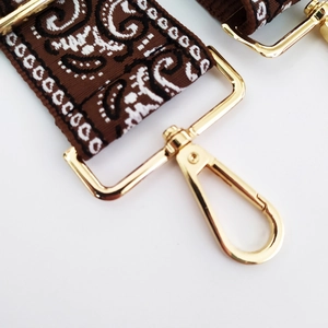 Detail of vintage wave pattern jacquard strap with polished gold lobster clasp